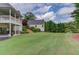Expansive backyard with well-maintained lawn, beautiful landscaping, and a detached structure in the distance at 4809 Highland Point Dr, Auburn, GA 30011