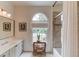 Bright bathroom featuring a window, white cabinets, a neutral color palette, and tiled shower at 4809 Highland Point Dr, Auburn, GA 30011