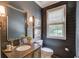 Stylish powder room with dark wood paneling and attractive decor at 4809 Highland Point Dr, Auburn, GA 30011