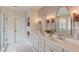 Modern bathroom featuring double sinks, decorative mirrors, and a glass enclosed shower at 4809 Highland Point Dr, Auburn, GA 30011