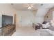 Spacious bedroom with two beds, accent wall, TV on dresser, and ceiling fan at 4809 Highland Point Dr, Auburn, GA 30011