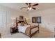 Charming bedroom with a wooden bed frame, ceiling fan, and decorative wall art at 4809 Highland Point Dr, Auburn, GA 30011