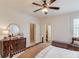 Inviting bedroom with dresser, neutral walls, ceiling fan, and comfortable furnishings at 4809 Highland Point Dr, Auburn, GA 30011