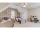 Charming bedroom with two beds, neutral decor, accent wall and a ceiling fan at 4809 Highland Point Dr, Auburn, GA 30011