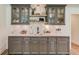Wet bar with gray cabinets, light countertops, open shelving, and stylish fixtures at 4809 Highland Point Dr, Auburn, GA 30011