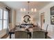 Formal dining room with elegant lighting, sophisticated window treatments, and a stylish table setting at 4809 Highland Point Dr, Auburn, GA 30011