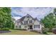 Charming two-story home with a manicured lawn, complemented by vibrant landscaping and classic architectural details at 4809 Highland Point Dr, Auburn, GA 30011