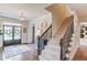 Bright and spacious foyer featuring a staircase, hardwood floors, and an inviting entrance with stylish decor at 4809 Highland Point Dr, Auburn, GA 30011