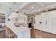Modern white kitchen with marble countertops, stainless steel appliances, and a center island at 4809 Highland Point Dr, Auburn, GA 30011