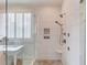 Walk-in shower with white tile surround and dual shower heads along with a makeup vanity at 4809 Highland Point Dr, Auburn, GA 30011
