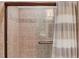 Tiled shower with glass door and curtain; well-lit and designed for accessibility and comfort at 4809 Highland Point Dr, Auburn, GA 30011