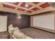 Home theater room with comfortable seating, large screen, and coffered ceilings is perfect for movie nights at 4809 Highland Point Dr, Auburn, GA 30011