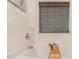 Luxurious soaking tub with bamboo blind-covered window and caddy at 220 Windpher Rdg, Hampton, GA 30228