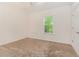 This cozy carpeted bedroom is brightened by a window at 220 Windpher Rdg, Hampton, GA 30228