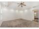 Carpeted bedroom featuring a tray ceiling with recessed lights and multiple doors at 220 Windpher Rdg, Hampton, GA 30228