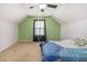 A bright bedroom with a ceiling fan and a green accent wall offers a comfortable space at 220 Windpher Rdg, Hampton, GA 30228