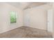 This carpeted bedroom benefits from a window and neutral walls at 220 Windpher Rdg, Hampton, GA 30228