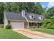 Traditional brick home with a two-car garage and a neatly maintained lawn at 220 Windpher Rdg, Hampton, GA 30228