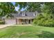 Charming brick home with a well-manicured lawn and inviting front porch at 220 Windpher Rdg, Hampton, GA 30228