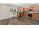 Modern kitchen featuring stainless steel appliances, wood cabinets and backyard access at 220 Windpher Rdg, Hampton, GA 30228