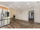 Open concept kitchen and living room with stainless steel appliances and brick fireplace at 220 Windpher Rdg, Hampton, GA 30228