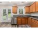 Cozy kitchen with stainless steel dishwasher and sink near backyard access at 220 Windpher Rdg, Hampton, GA 30228