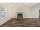Bright living room with a vaulted ceiling, fireplace, and modern flooring at 220 Windpher Rdg, Hampton, GA 30228