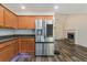 Open concept living room view featuring stainless steel refrigerator and cozy fireplace at 220 Windpher Rdg, Hampton, GA 30228
