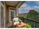 Cozy balcony with seating and a view of the surrounding buildings and greenery at 2300 Peachford Rd # 3411, Dunwoody, GA 30338