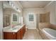 Bathroom featuring double sinks, a soaking tub, and a separate shower at 2300 Peachford Rd # 3411, Dunwoody, GA 30338