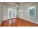 Bedroom with hardwood floors, ceiling fan, and sliding doors leading to a balcony at 2300 Peachford Rd # 3411, Dunwoody, GA 30338