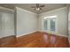 Bedroom with hardwood floors, ceiling fan, and french doors leading to a balcony at 2300 Peachford Rd # 3411, Dunwoody, GA 30338