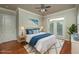 Comfortable bedroom with hardwood floors, a ceiling fan, and access to a balcony for relaxing outdoor enjoyment at 2300 Peachford Rd # 3411, Dunwoody, GA 30338