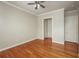 Bedroom with hardwood floors, neutral walls, ceiling fan, and two closets at 2300 Peachford Rd # 3411, Dunwoody, GA 30338