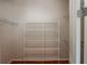 Walk-in closet with metal shelving and hardwood floors for organized storage at 2300 Peachford Rd # 3411, Dunwoody, GA 30338