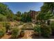 Lush community garden with raised beds and walking paths, offering residents a space for gardening and relaxation at 2300 Peachford Rd # 3411, Dunwoody, GA 30338