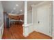 Entryway with wood floors that leads to the kitchen featuring stainless appliances and a decorative column at 2300 Peachford Rd # 3411, Dunwoody, GA 30338