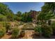 View of the community garden with raised beds and greenery at 2300 Peachford Rd # 3411, Dunwoody, GA 30338