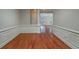 Entry hall featuring wood floors, with a partial view of the living room and kitchen at 2300 Peachford Rd # 3411, Dunwoody, GA 30338