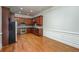 Spacious kitchen featuring stainless steel appliances, granite countertops, wood cabinetry, and wood floor at 2300 Peachford Rd # 3411, Dunwoody, GA 30338