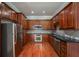 Galley kitchen features stainless steel appliances, granite countertops, and wood cabinets at 2300 Peachford Rd # 3411, Dunwoody, GA 30338