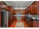 Galley kitchen with stainless steel appliances, granite countertops, and cherry wood cabinets at 2300 Peachford Rd # 3411, Dunwoody, GA 30338