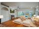 Open concept living room with hardwood floors, white built-ins, fireplace, ceiling fan, and lots of natural light at 2300 Peachford Rd # 3411, Dunwoody, GA 30338
