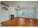 Spacious living room with hardwood floors, fireplace, and built-in shelving at 2300 Peachford Rd # 3411, Dunwoody, GA 30338