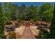 Wide shot of the outdoor patio with lush landscaping and grilling station at 2300 Peachford Rd # 3411, Dunwoody, GA 30338