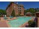 Outdoor pool area with lounge chairs, tables, and covered pavilion at 2300 Peachford Rd # 3411, Dunwoody, GA 30338