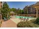 Swimming pool area with lounge chairs and beautiful landscaping surrounding the brick patio at 2300 Peachford Rd # 3411, Dunwoody, GA 30338