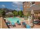 Relaxing pool area surrounded by lounge chairs and lush landscaping on a sunny day at 2300 Peachford Rd # 3411, Dunwoody, GA 30338
