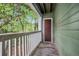 Outdoor balcony with green siding and view of trees at 328 Bentley Pl # 328, Tucker, GA 30084