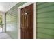 Exterior door with green siding and white trim, showing the unit number and hardware at 328 Bentley Pl # 328, Tucker, GA 30084